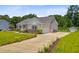 A single-story home with a two-car garage, long driveway, garden beds, and a lawn at 708 Tierra Loop, Summerville, SC 29483