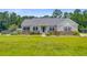 Well-maintained one story home with mature landscaping, light colored siding, stone veneer and large front yard at 708 Tierra Loop, Summerville, SC 29483