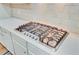 Close up of a modern stainless steel gas cooktop with cream subway tile backsplash at 708 Tierra Loop, Summerville, SC 29483