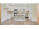 Kitchen with stone kitchen island, stainless appliances and white cabinets at 708 Tierra Loop, Summerville, SC 29483