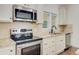 Modern kitchen featuring stainless steel appliances, light countertops, and tile backsplash at 708 Tierra Loop, Summerville, SC 29483
