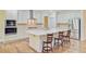 Modern kitchen with stainless steel appliances, wooden floors, and an island with bar stool seating at 708 Tierra Loop, Summerville, SC 29483