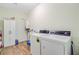 Well-lit laundry room with modern washer and dryer, storage cabinet, and utility sink at 708 Tierra Loop, Summerville, SC 29483