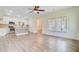 Open-concept kitchen and living area with wood floors and windows at 708 Tierra Loop, Summerville, SC 29483