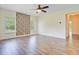 Open-concept living room with a stone accent wall and wood floors at 708 Tierra Loop, Summerville, SC 29483
