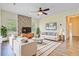 The living room features lots of natural light, ceiling fan, stone accent wall, and modern furniture at 708 Tierra Loop, Summerville, SC 29483