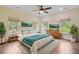 Bright primary bedroom featuring four large windows, ceiling fan and wood flooring at 708 Tierra Loop, Summerville, SC 29483