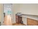 A modern office nook with a stone countertop, brown cabinets and wood floors at 708 Tierra Loop, Summerville, SC 29483