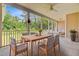 Large screened porch with dining area and seating, plus wooded view beyond at 708 Tierra Loop, Summerville, SC 29483