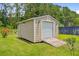This storage shed has neutral siding, lighting, a garage door, and ramp access at 708 Tierra Loop, Summerville, SC 29483