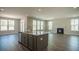 Inviting living room with a fireplace and large windows offering an abundance of natural light at 713 Breakers Reef Ln, Huger, SC 29450