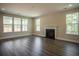 Bright and airy living room featuring a classic fireplace and ample natural light at 713 Breakers Reef Ln, Huger, SC 29450