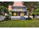 Charming back porch with screened-in patio, white picket fence, and a well-manicured lawn at 721 Lake Frances Dr, Charleston, SC 29412