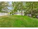 Lush green backyard with mature trees and landscaping, offering a private outdoor space at 721 Lake Frances Dr, Charleston, SC 29412