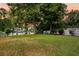 Expansive backyard with lush lawn, mature trees, and a view of the lake at 721 Lake Frances Dr, Charleston, SC 29412