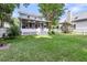 Spacious backyard featuring a well-maintained lawn, screened-in porch and a charming white picket fence at 721 Lake Frances Dr, Charleston, SC 29412