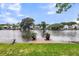 Waterfront backyard featuring a small dock, lush green grass, and tranquil water view at 721 Lake Frances Dr, Charleston, SC 29412