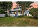 Expansive backyard with a screened-in porch and lush landscaping perfect for outdoor living at 721 Lake Frances Dr, Charleston, SC 29412