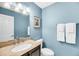 Well-lit half bathroom featuring granite countertops and blue painted walls at 721 Lake Frances Dr, Charleston, SC 29412