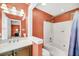 Well-lit bathroom features a combined shower and bathtub, vanity with sink and tiled floors at 721 Lake Frances Dr, Charleston, SC 29412
