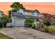 Charming two-story home boasts a well-maintained exterior with a driveway and colorful landscaping at 721 Lake Frances Dr, Charleston, SC 29412