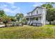 Beautiful two-story home with a welcoming front porch, manicured lawn, and lush landscaping at 721 Lake Frances Dr, Charleston, SC 29412