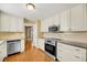 This kitchen has stainless steel appliances, granite countertops, and hardwood floors at 721 Lake Frances Dr, Charleston, SC 29412