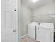 Functional laundry room with washer, dryer, and ample shelving for storage at 721 Lake Frances Dr, Charleston, SC 29412