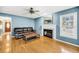 Stylish living room with hardwood floors, a fireplace, and a comfortable leather couch at 721 Lake Frances Dr, Charleston, SC 29412