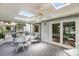Cozy screened-in porch with comfortable seating and a ceiling fan, perfect for outdoor relaxation at 721 Lake Frances Dr, Charleston, SC 29412