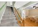 Inviting staircase with wooden railing leading to an open-concept dining and kitchen area at 721 Lake Frances Dr, Charleston, SC 29412