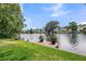 Waterfront view with a serene lake, private dock, and lush greenery, ideal for relaxation and outdoor enjoyment at 721 Lake Frances Dr, Charleston, SC 29412