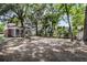 Spacious backyard with mature trees, lush greenery, and lots of parking at 727 Savannah Hwy, Charleston, SC 29407