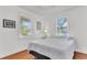 Bright bedroom with hardwood floors, ceiling fan, and sunlit windows with neighborhood views at 727 Savannah Hwy, Charleston, SC 29407