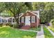Charming brick home with manicured lawn, classic architectural details, and paved driveway at 727 Savannah Hwy, Charleston, SC 29407