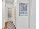 Hallway view leads to bathroom, showing patterned rug and closet with cane inserts at 727 Savannah Hwy, Charleston, SC 29407
