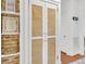 Hallway with laundry cupboard and wall decor that leads to another room at 727 Savannah Hwy, Charleston, SC 29407