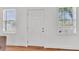 Bright interior shot featuring a white six-panel door with windows, hardwood floor, and light walls at 727 Savannah Hwy, Charleston, SC 29407