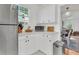 Bright kitchen featuring white cabinets, stainless steel appliances, and a view into the living room at 727 Savannah Hwy, Charleston, SC 29407