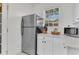 Kitchen showcasing stainless steel refrigerator, white cabinets, and modern microwave at 727 Savannah Hwy, Charleston, SC 29407