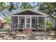 Inviting screened porch with brick foundation, white railings, and exterior lighting at 727 Savannah Hwy, Charleston, SC 29407