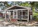 Charming screened porch with brick steps, wood railings, and a fan for comfortable outdoor living at 727 Savannah Hwy, Charleston, SC 29407