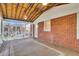 Inviting screened porch with wood flooring, ceiling fans, brick wall, and a cozy atmosphere at 727 Savannah Hwy, Charleston, SC 29407