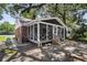 Inviting screened porch with brick foundation, white railings, and exterior lighting at 727 Savannah Hwy, Charleston, SC 29407
