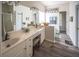 Bright bathroom featuring double sinks, vanity, large mirror, and tiled flooring at 808 Long Drive Rd, Summerville, SC 29485