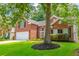 A charming brick home boasts a well-kept lawn, landscaped flower beds and a two-car garage at 808 Long Drive Rd, Summerville, SC 29485