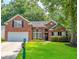A charming two-story red brick home with a well-kept lawn and landscaped flower beds at 808 Long Drive Rd, Summerville, SC 29485