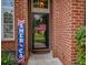 Inviting front door framed by decorative details, brick, and colorful landscaping at 808 Long Drive Rd, Summerville, SC 29485