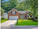 Charming brick home with a well-manicured lawn, two-car garage, and lovely landscaping at 808 Long Drive Rd, Summerville, SC 29485