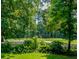View of a manicured golf course with mature trees and sand traps in the background at 808 Long Drive Rd, Summerville, SC 29485